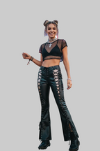 Lifestyle image - model at festival wearing faux leather flare pants