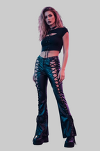 Lifestyle image - model in urban nightlife setting wearing faux leather flare pants